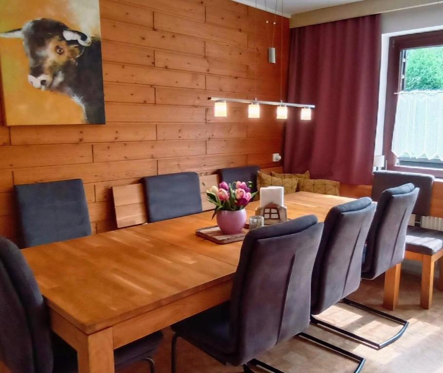a dining room with a wooden table and chairs at Ferienwohnung Schädler in Tschagguns
