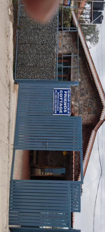 two blue stairs with a sign on top of a building at Friends cottage in Coonoor