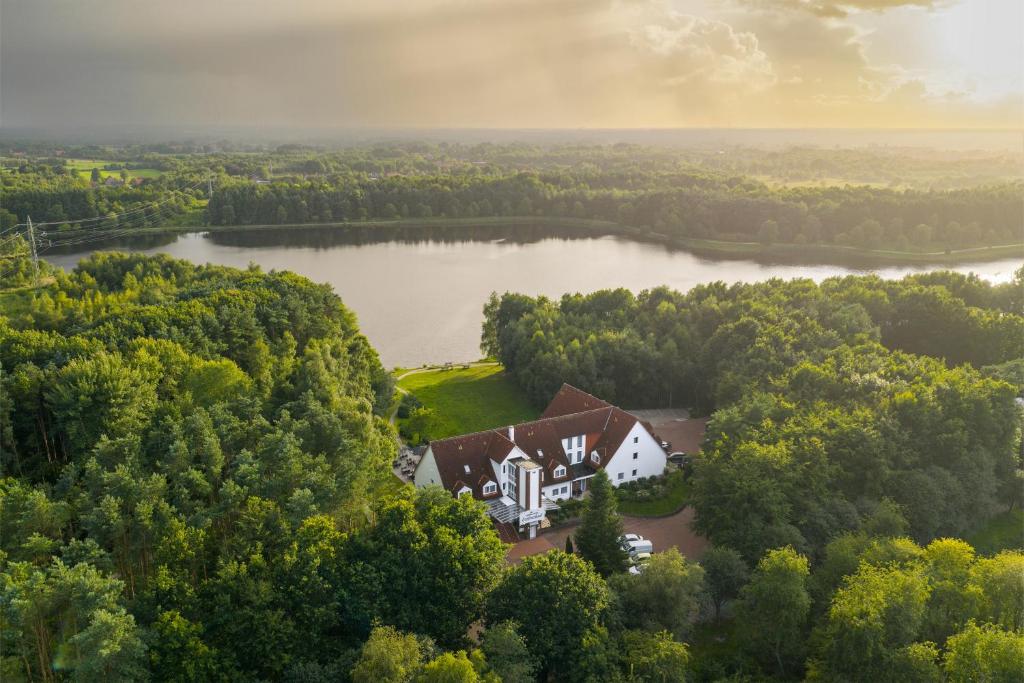 an aerial view of a house in the middle of a lake at Ferien Hotel Ostfriesland in Wiesmoor