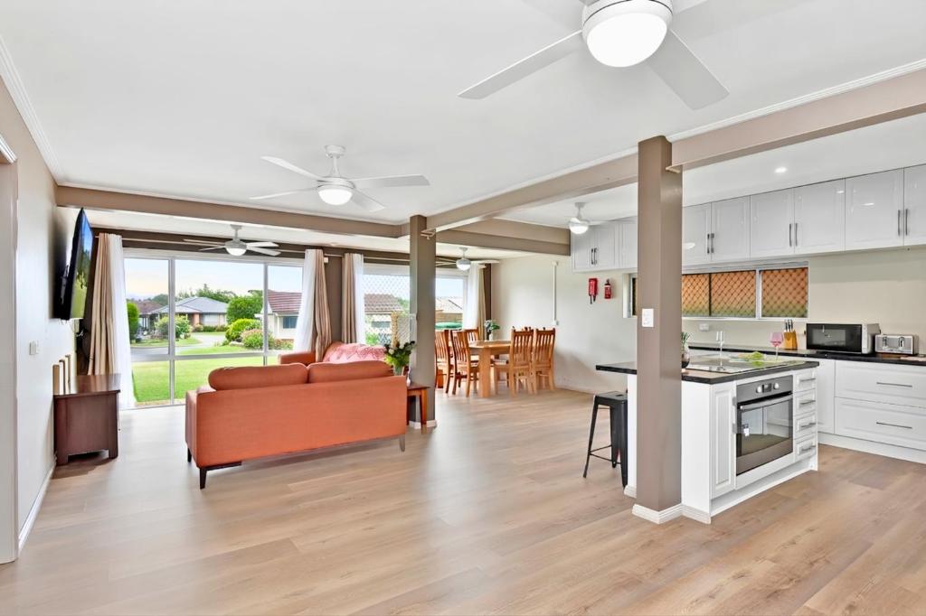 a kitchen and living room with a couch and a table at Coal d' Vine Chillout - Cessnock NSW in Cessnock