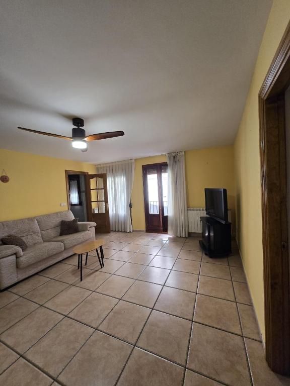 a living room with a couch and a tv at Apartamento Ioar in Los Arcos