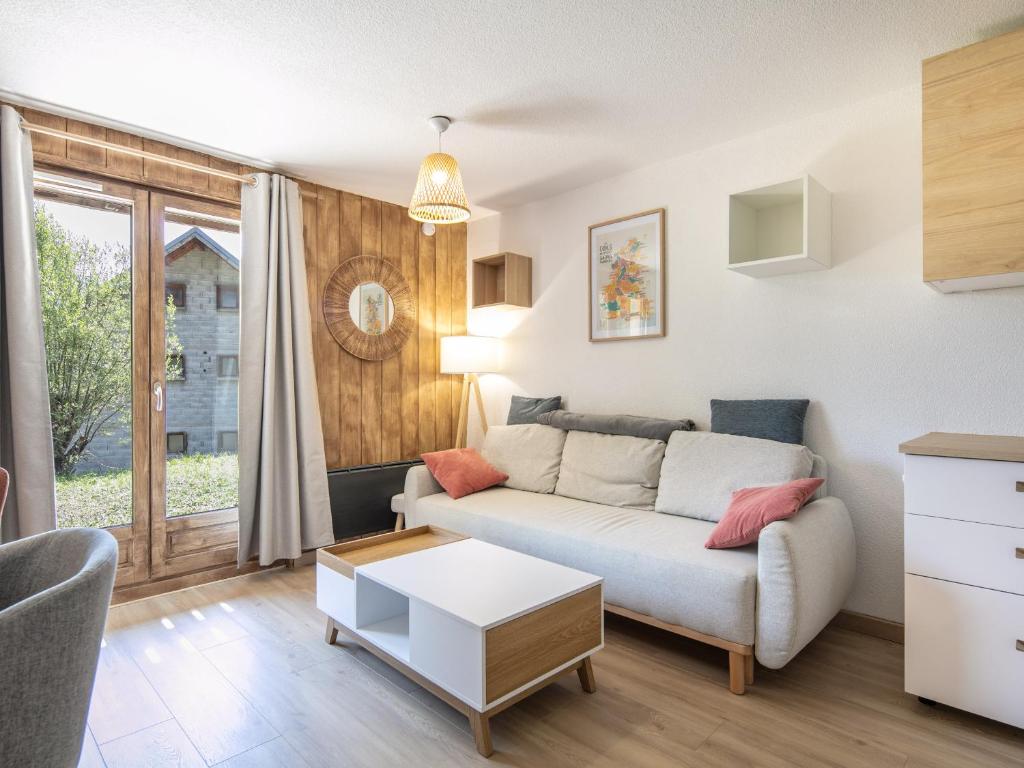 a living room with a couch and a table at Les Grizzlis N 20 - 2P6 in Saint-Sorlin-dʼArves
