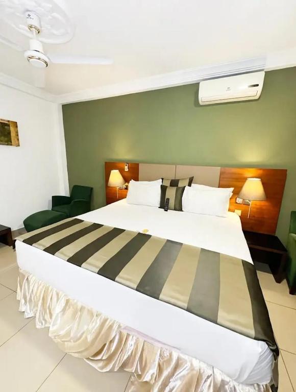 a hotel room with a large bed in a room at Mr smith hotel in Accra