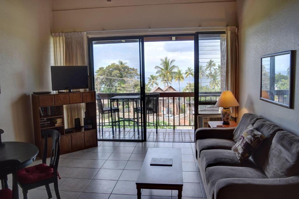 a living room with a couch and a large window at Maui Vista 1411 in Kihei
