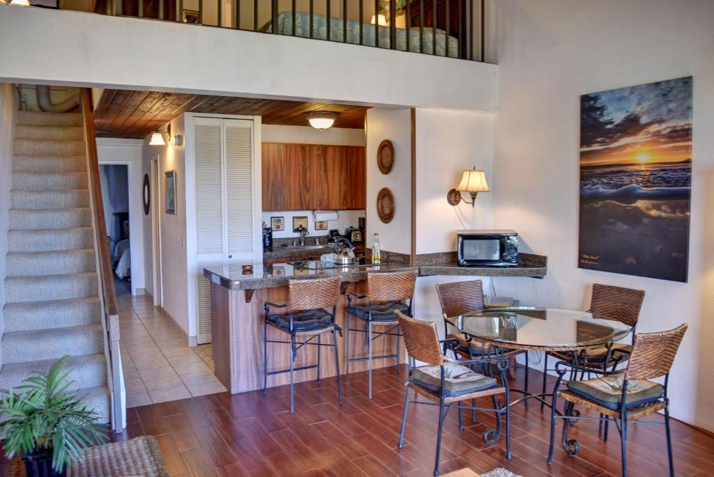 a kitchen and dining room with a table and chairs at Maui Vista 1422 in Kihei
