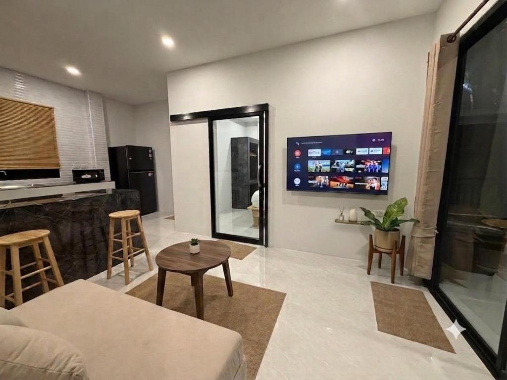 a living room with a couch and a table at Greenway in Hinkong