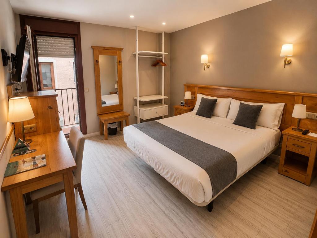 a hotel room with a large bed and a window at Alda A Boira in Jaca