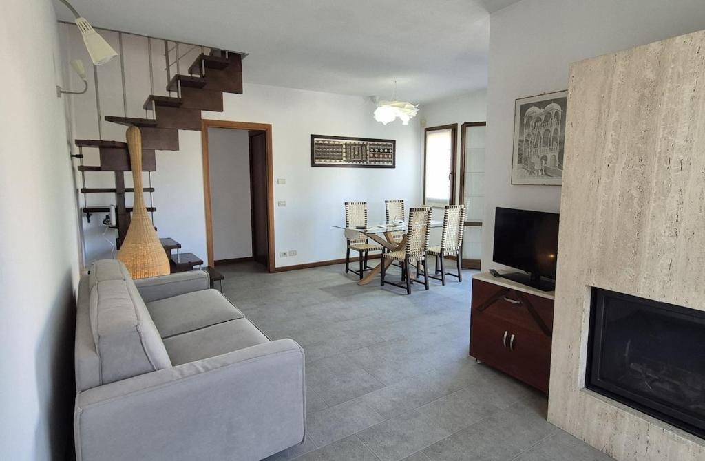 a living room with a couch and a television at Santarcangelo Stay Your Perfect Base in Romagna in Santarcangelo di Romagna
