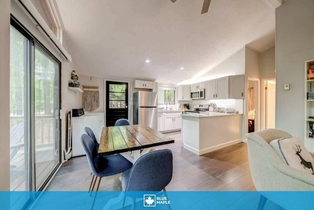 a kitchen with a wooden table and chairs in a room at Cozy Pet-Friendly w Fire Pit, Wifi & Pool Access in Hedgesville