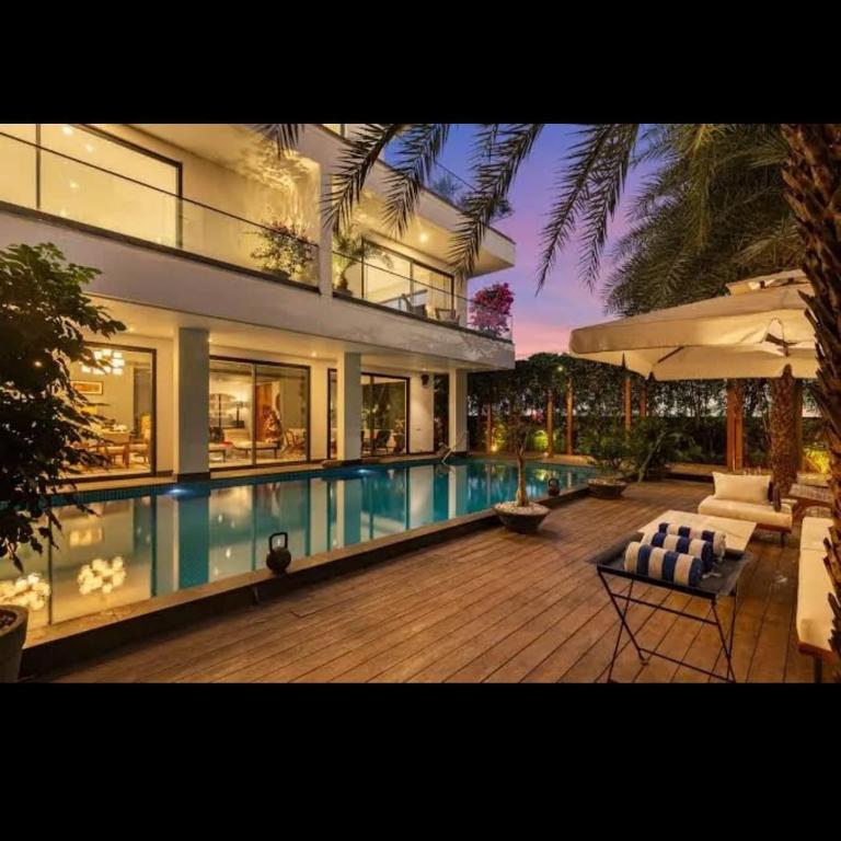 a large house with a swimming pool in front of it at amarzito villa in Dona Paula