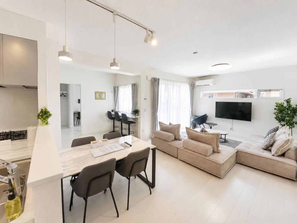 a kitchen and living room with a table and chairs at Miyako Beach Resort in Hirara