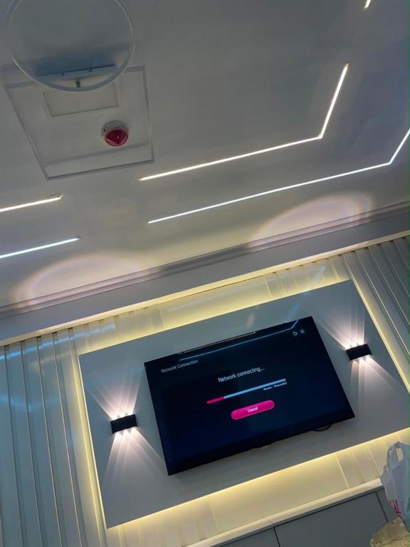 a tv on the ceiling of a room at Teddy apartment in Lagos