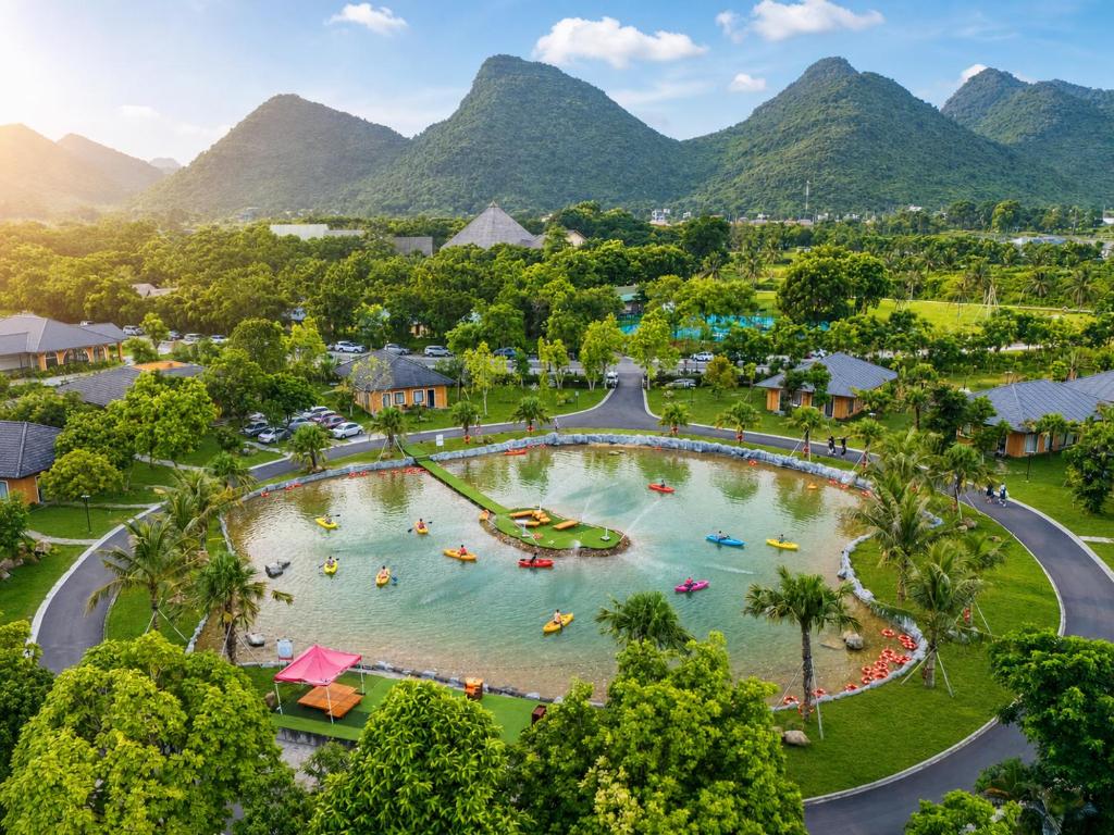 an aerial view of a resort with mountains in the background at Cuc Phuong Tropical Villas in Thượng Sung