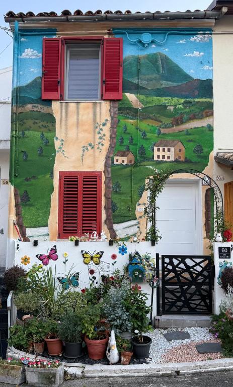 a mural on the side of a building with plants at Casa Belvedere in Serradica