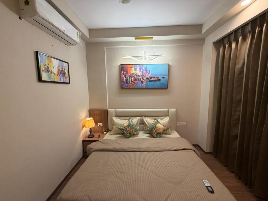 a bedroom with a bed and a painting on the wall at M R ComfortHeaven in Greater Noida