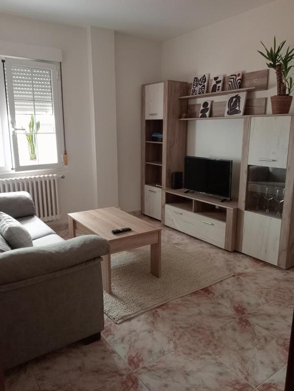 a living room with a couch and a table at Casa Oskar in Avilés