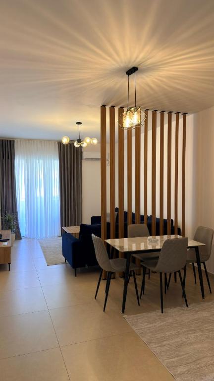 a dining room with a table and chairs at Ayzal Apartment in Shëngjin