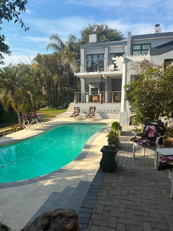 a house with a swimming pool in front of it at House Foxglove in Paarl