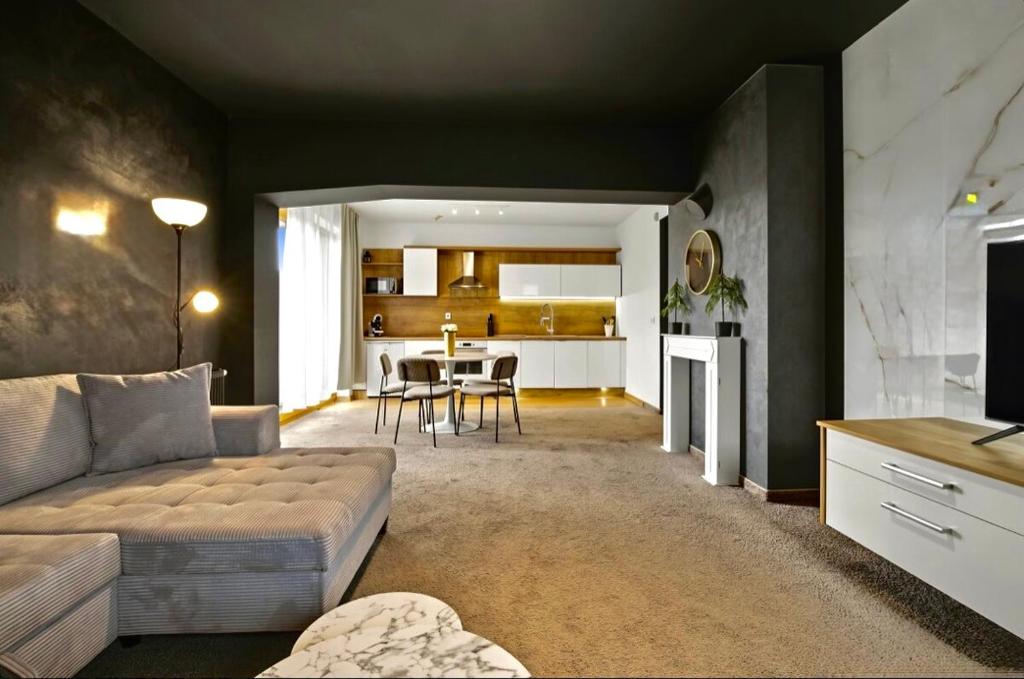 a living room with a couch and a table at Donovaly Residence Apartment 111 in Donovaly