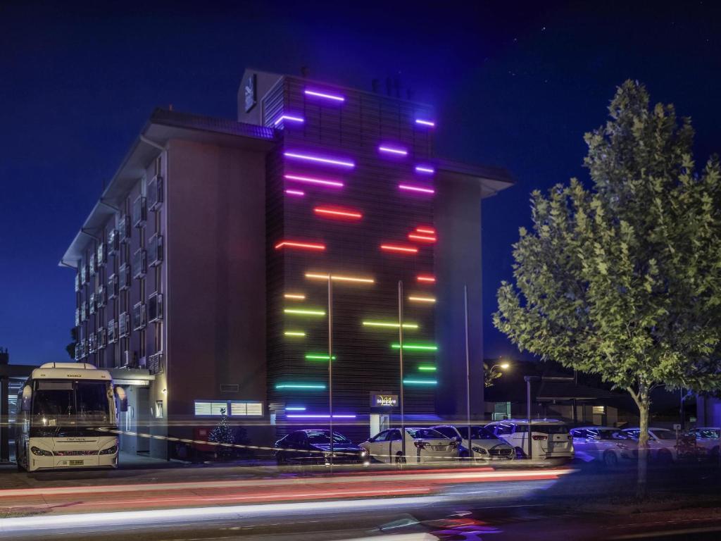 a building with colorful lights on it at night at Mercure Albury in Albury