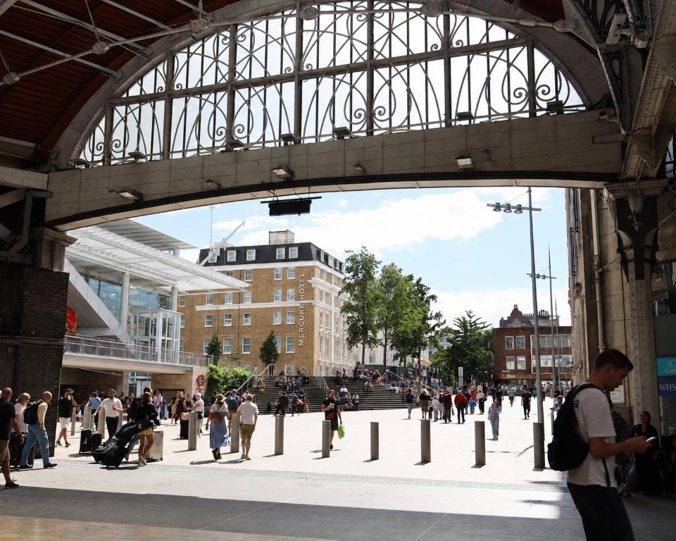 a group of people walking around a city at Mercure London Paddington Hotel in London