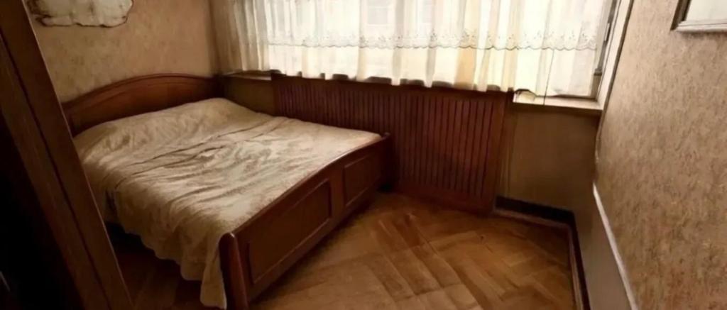 a small bed in a small room with a window at Arman in Yerevan