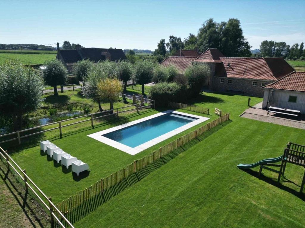 an overhead view of a yard with a swimming pool at Authentic rural square farm in Poperinge