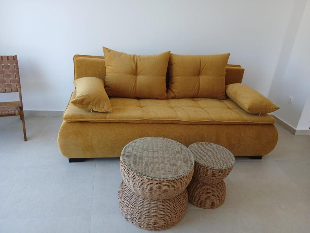 a couch with pillows and two tables in a living room at Villa Prado in Almiros Beach