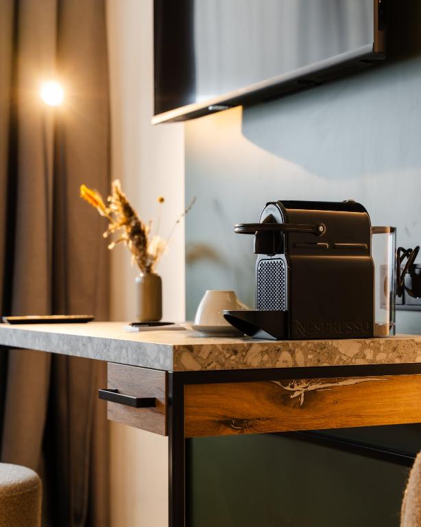 a table with a coffee maker on top of it at Hotel Sittardsberg in Duisburg