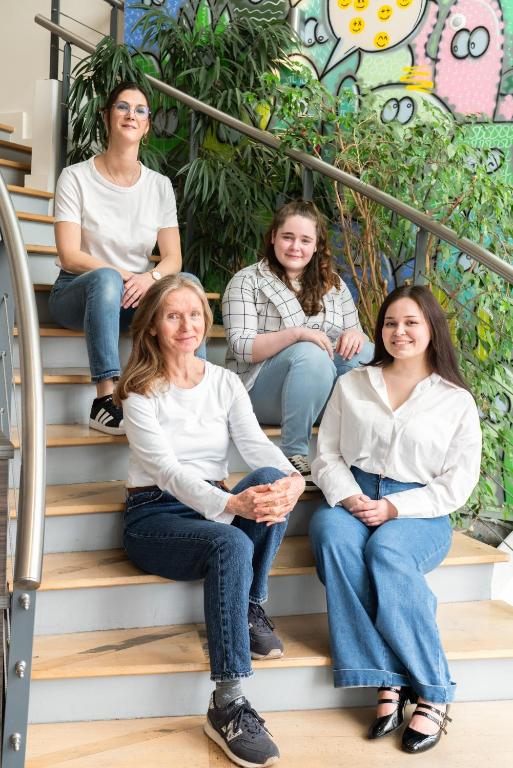 a group of women sitting on the stairs at The Originals Residence Appart Hôtel Hévéa Valence in Valence