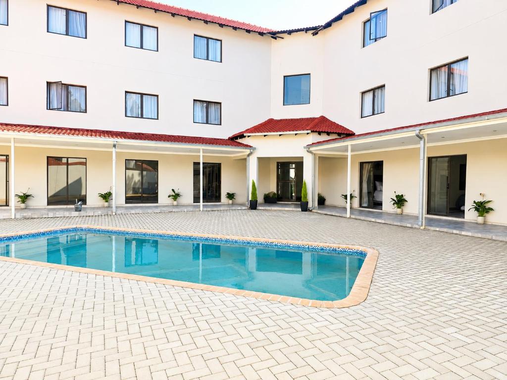 a swimming pool in front of a building at Cleopatra Palace in Vereeniging