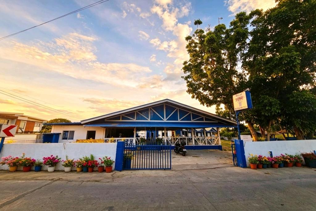 a building with a blue gate in front of it at B'lu Bamboo in Moalboal
