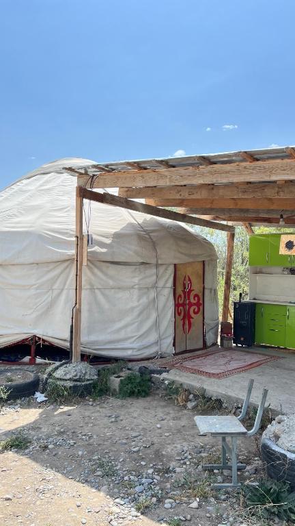 a large tent with a bench in front of a building at ЭКО БАЛЫК Седеп Юурты 