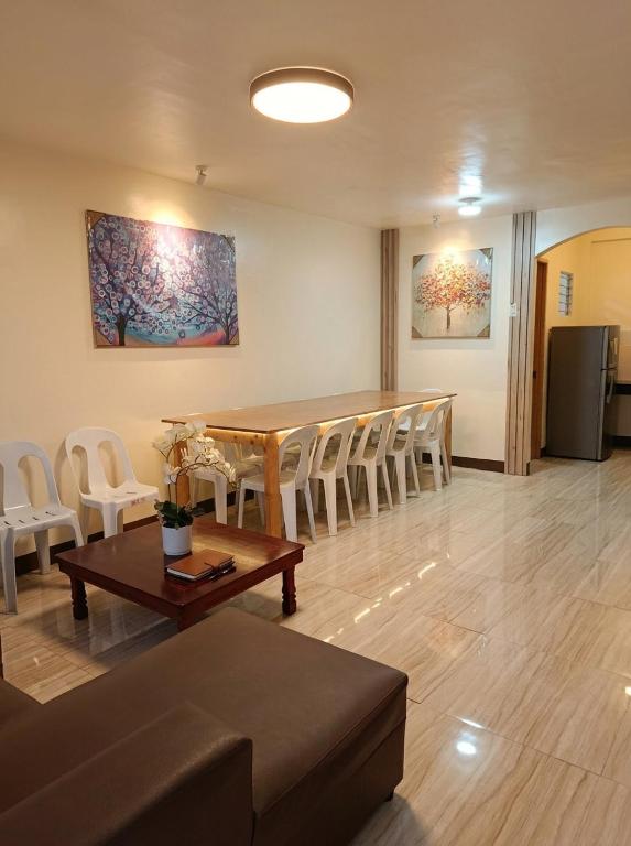 a living room with a table and chairs at Ysamatti Travel Lodge in Bankal