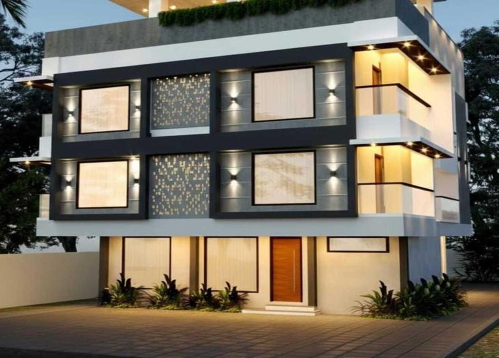a rendering of a building with lights on at Lucy Residences in Ernakulam