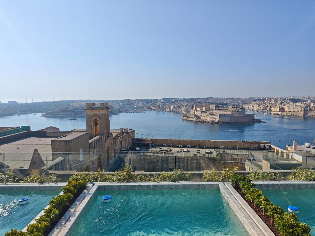 a large swimming pool with a view of the river at Ursulino Valletta in Valletta