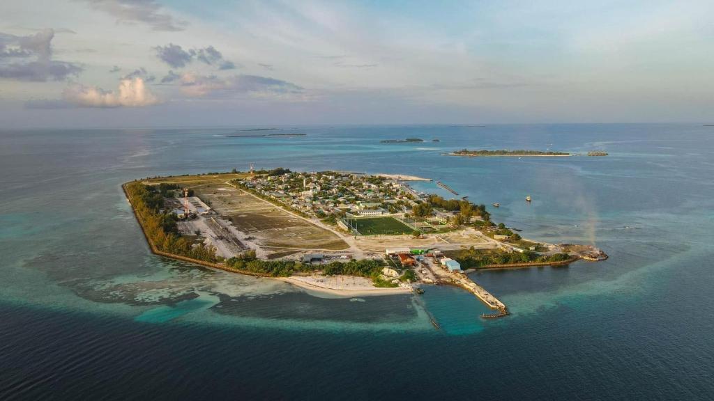 an island in the ocean with a rainbow on it at The Sultanate Courtyard Lh Hinnavaru 