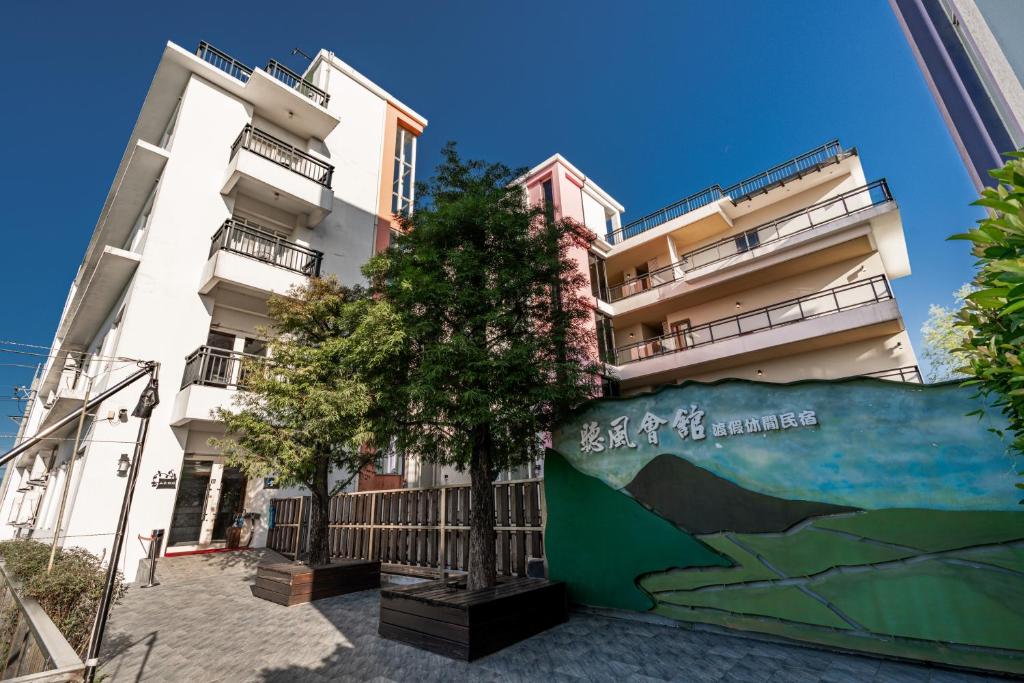 a building with a tree in front of it at 聽風會館 in Yuanshan