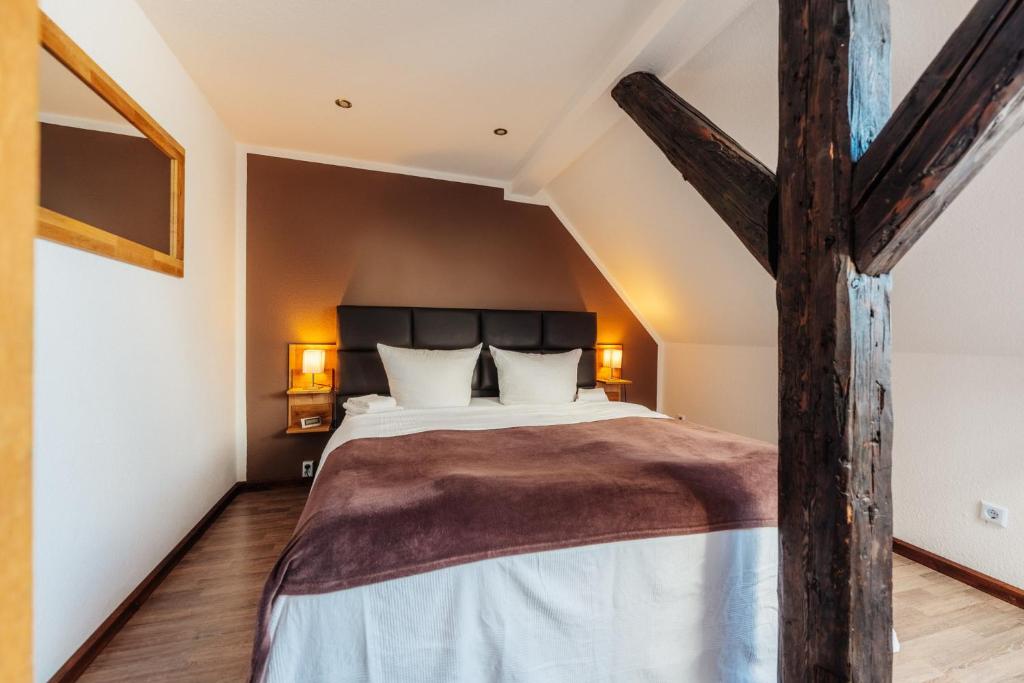 a bedroom with a large bed in a attic at Fichtenblick in Sankt Andreasberg
