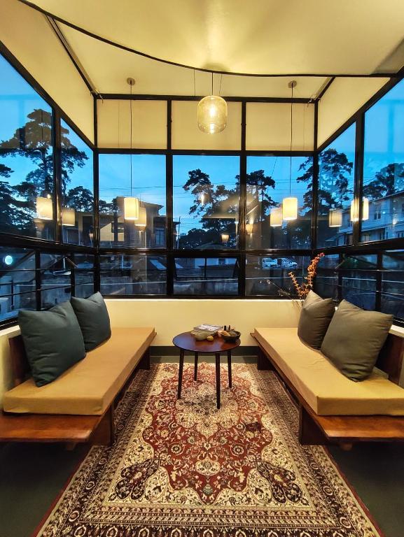 a living room with two couches and a table at Urbanest B&B in Shillong