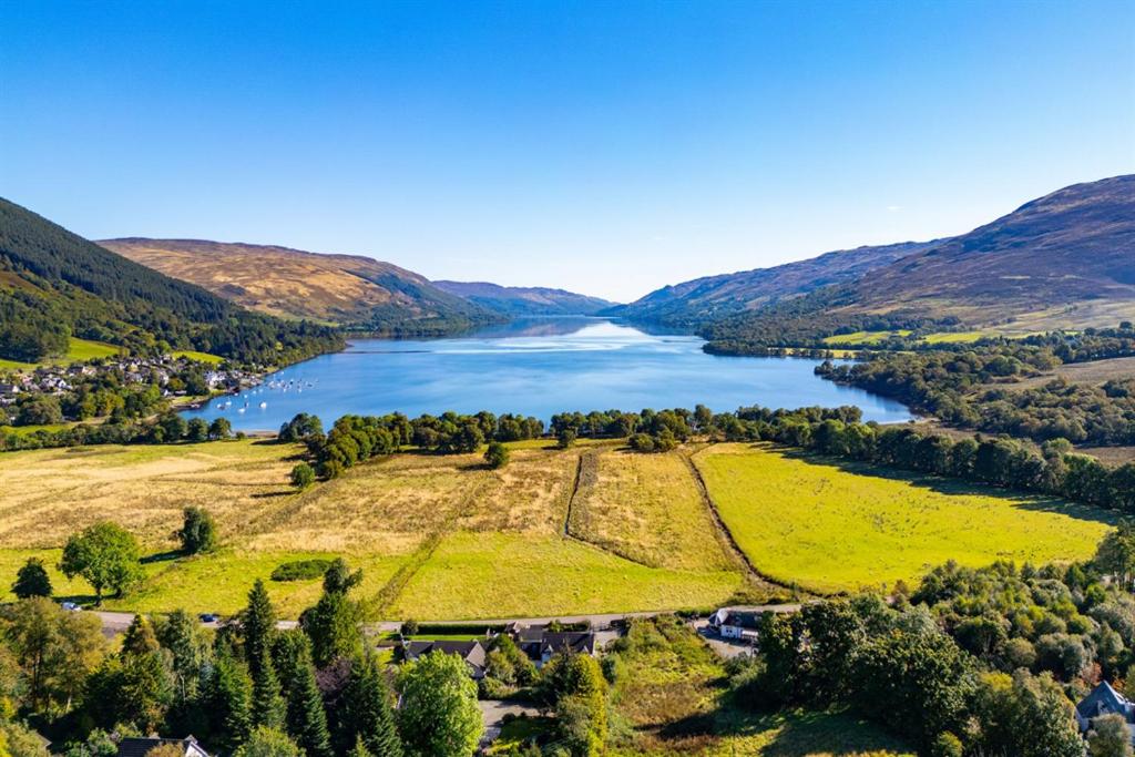 an aerial view of a lake in the hills at Meadowview in Lochearnhead