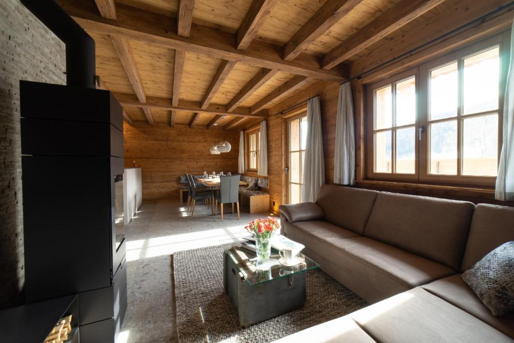 a living room with a couch and a table at Chalet Selun - Luxury & Bergblick in Wildhaus