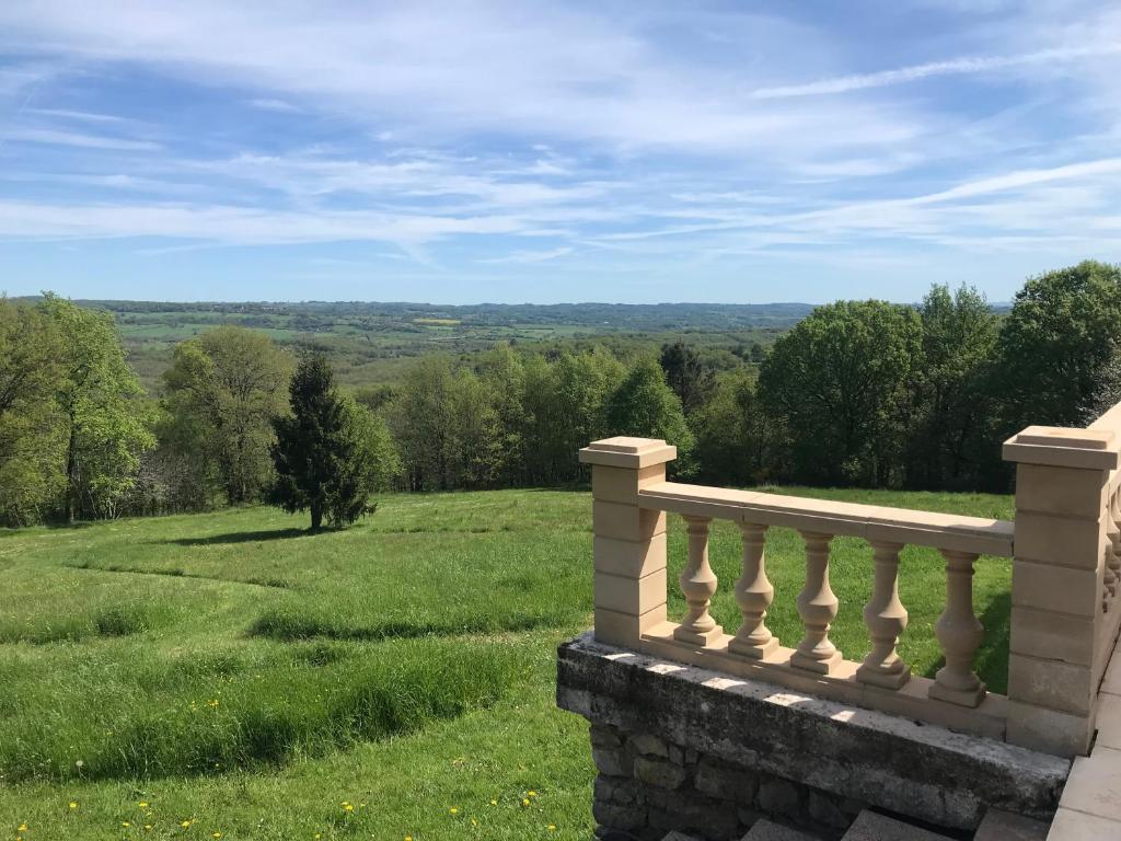 a balcony of a house with a view of a field at B&B Manoir Calmeer in Thenon