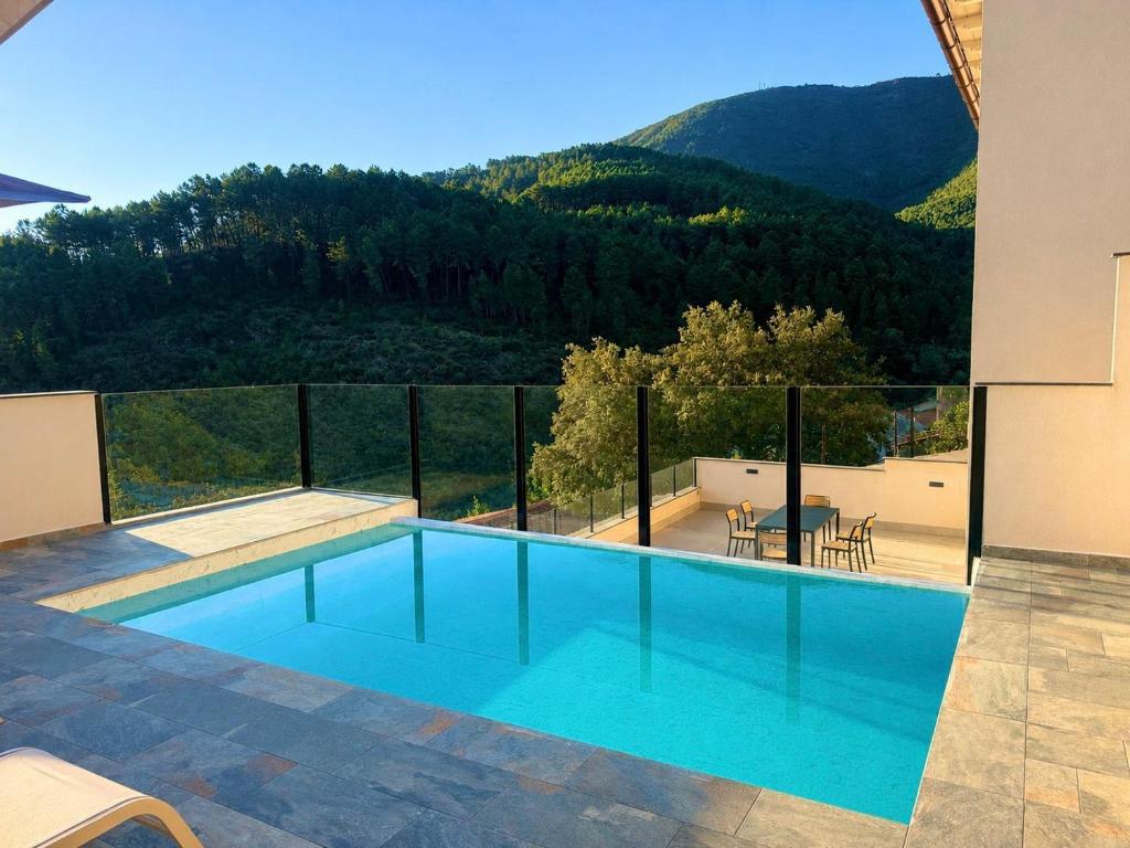 a swimming pool with a view of a mountain at LURDE Apartamentos Rurales in El Cerezal