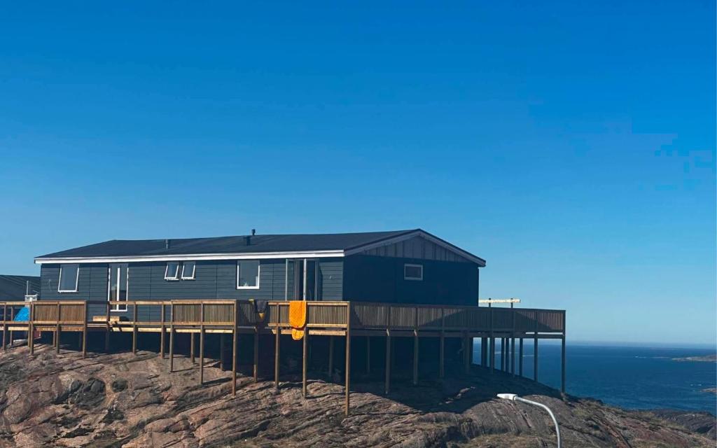 a house on the side of a cliff at Isi4u apartments, snowmobile and dogsled in Sisimiut