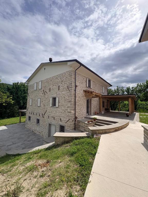 a large brick building with a ramp in front of it at Vessa 3 in Selvapiana