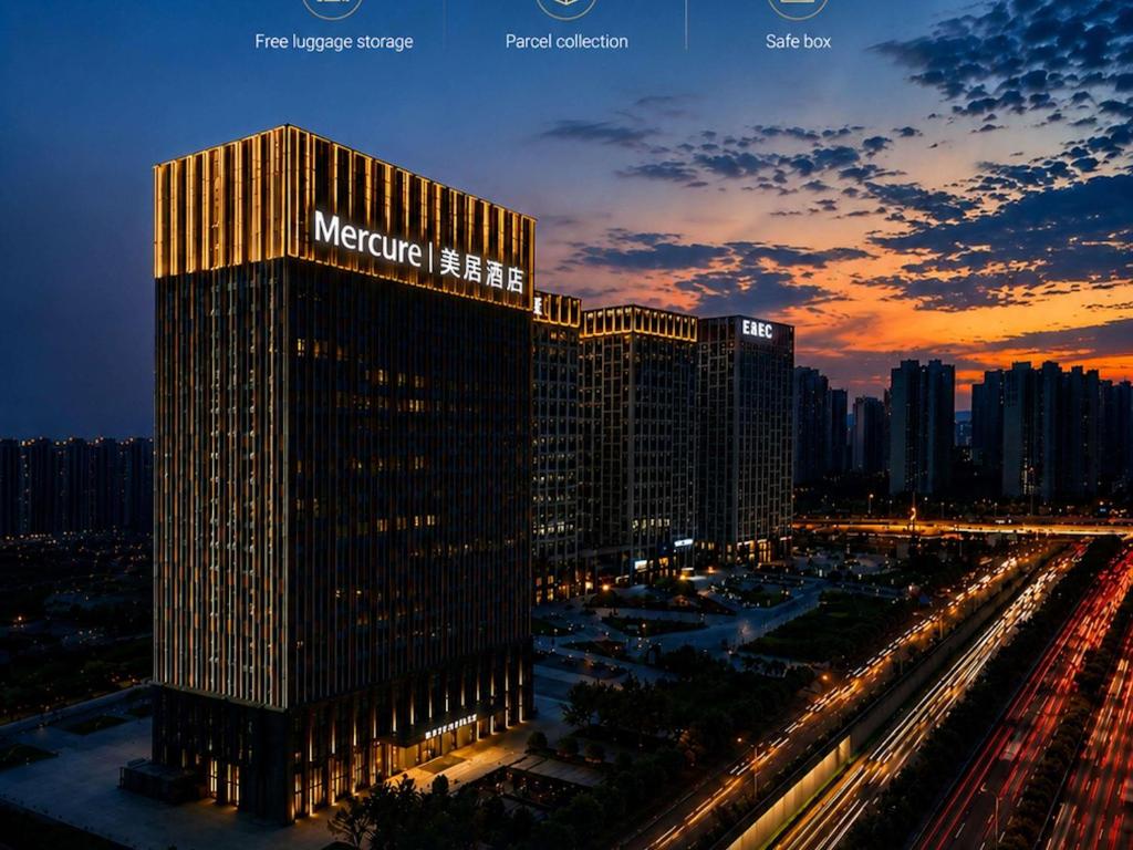 a large building with a sign on it at night at Mercure Xi'an Qujiang in Xi'an