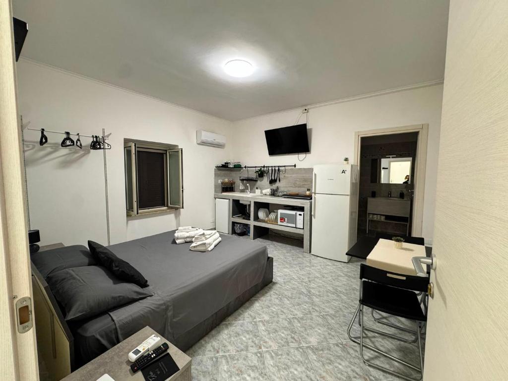a bedroom with a bed and a desk and a television at Eden Affittacamere in Anzio