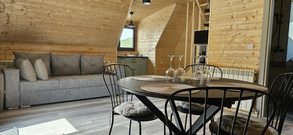 a room with a table and chairs and a couch at E&T-Cabin A frame in Sibiu