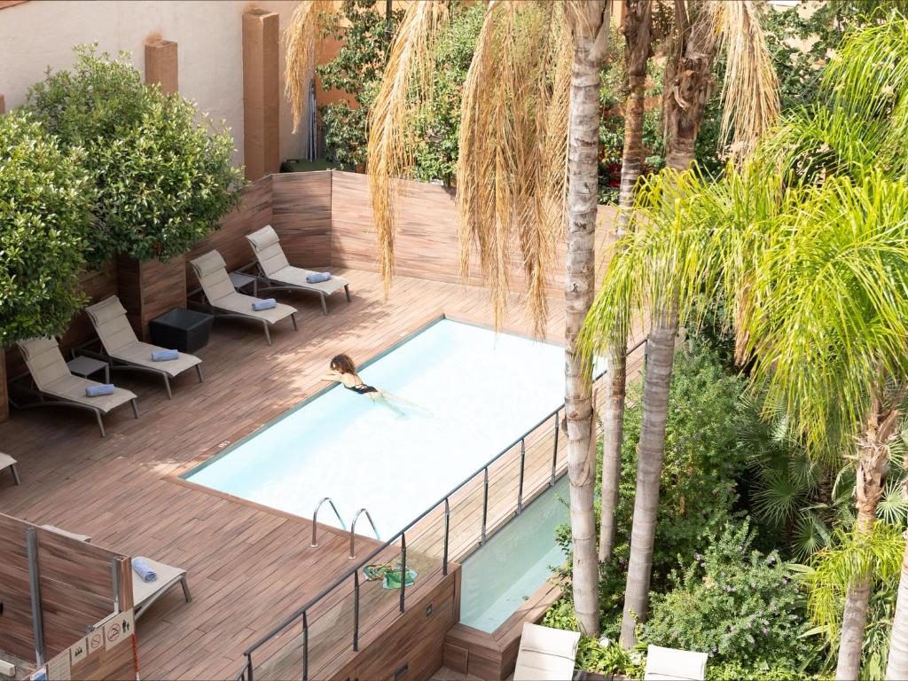 an overhead view of a swimming pool on a wooden deck at Catalonia Portal de l'Angel in Barcelona